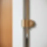 Close up of a modern hinge on a bathroom vanity door showcasing sleek design